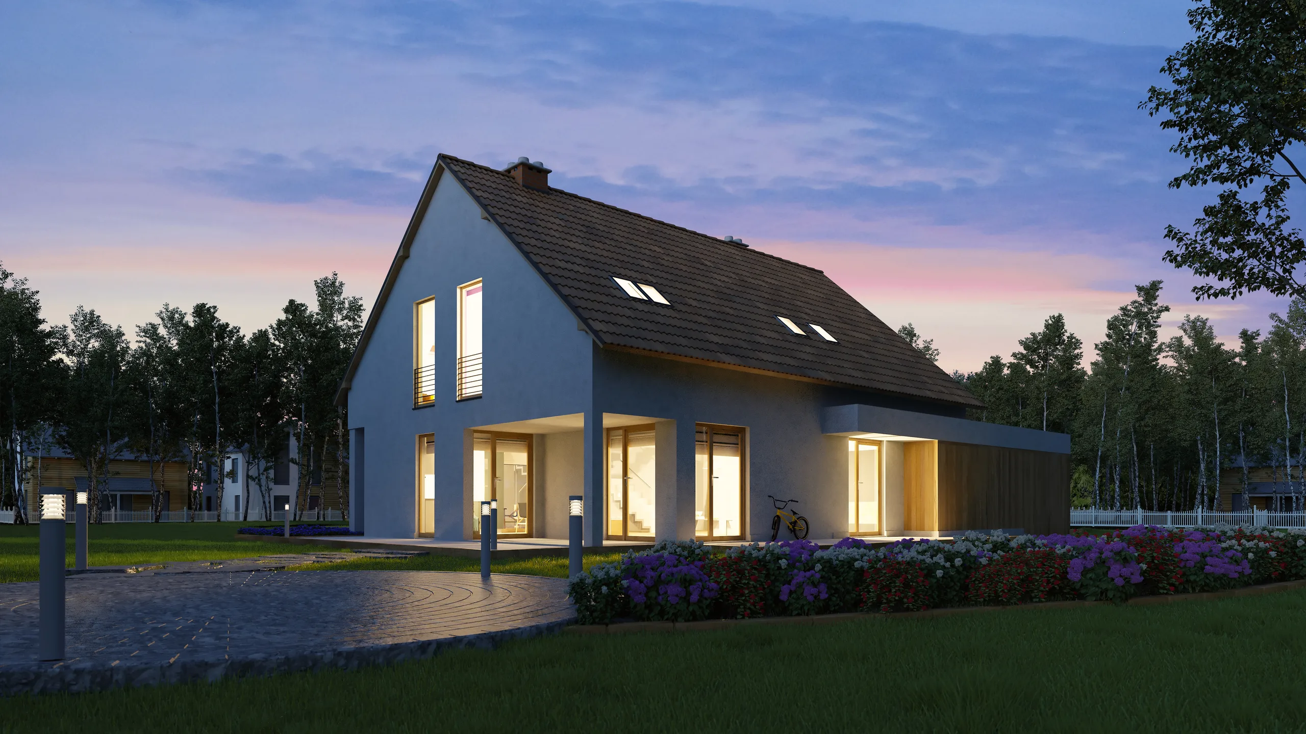 Modernes Einfamilienhaus mit beleuchtetem Garten in der Abenddämmerung